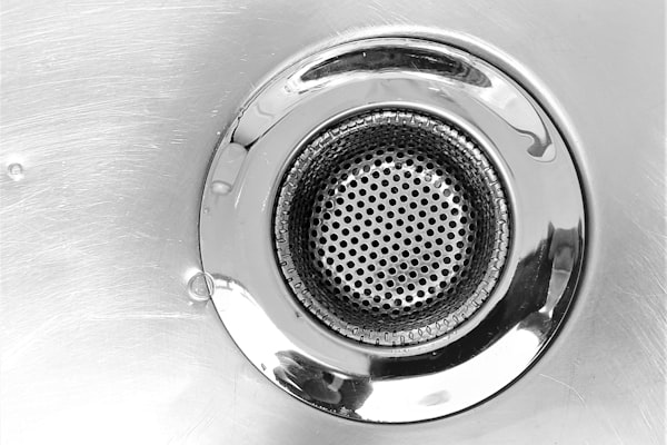 Stainless steel drain closeup for emergency plumbing